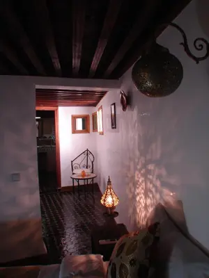 a living room with a table and a lamp at Riad Sheryne Fes in Fès