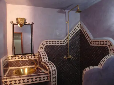 a bathroom with a sink and a mirror at Riad Sheryne Fes in Fès