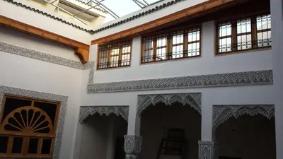a room with windows and a door in a building at Riad Sheryne Fes in Fès