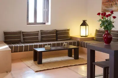 a living room with a couch and a table at Ecolodge Quaryati Marrakech in Douar Tounsi