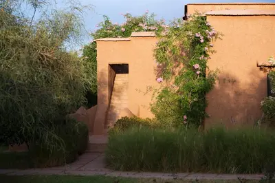 a building with a doorway with flowers on it at Ecolodge Quaryati Marrakech in Douar Tounsi