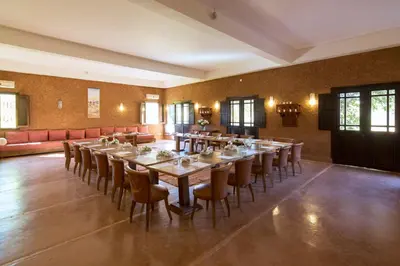 a large dining room with a long table and chairs at Ecolodge Quaryati Marrakech in Douar Tounsi