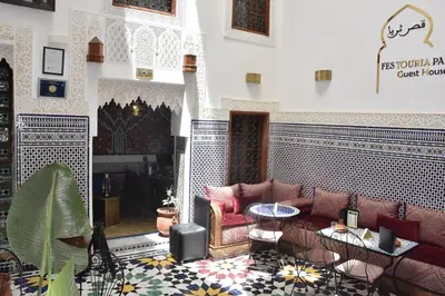a living room with a couch and a table at Riad Fes Touria Palace in Fès