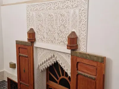 a white wall with a white patterned wall at Riad Fes Touria Palace in Fès