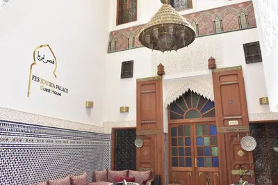 a lobby of a mosque with a large wooden door at Riad Fes Touria Palace in Fès