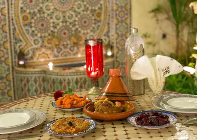a table with plates and bowls of food on it at Riad Jardin Chrifa in Fès