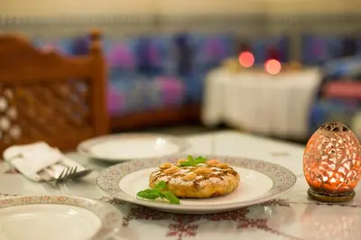a plate with a pastry on a table at Riad Jardin Chrifa in Fès