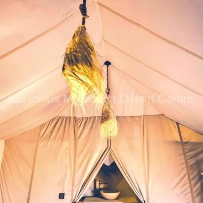 a tent with tassels hanging from the ceiling at Luxurious Merzouga Desert Camps in Merzouga