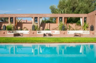 a villa with a swimming pool in front of a house at Dar Chamaa in Ouarzazate