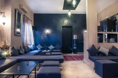 a living room with blue couches and a blue wall at Dar Chamaa in Ouarzazate