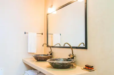 two sinks in a bathroom with a large mirror at Dar Chamaa in Ouarzazate