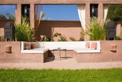 a patio with two white couches and a table at Dar Chamaa in Ouarzazate