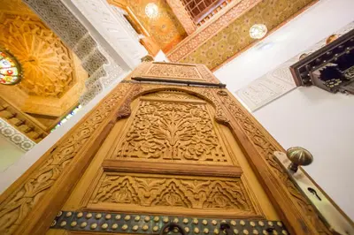 an ornate wooden door in a building at Dar Mfaddel in Fès