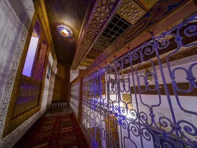 a hallway with a wall covered in stained glass at Dar Mfaddel in Fès
