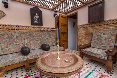 a living room with a couch and a table at Dar Mfaddel in Fès