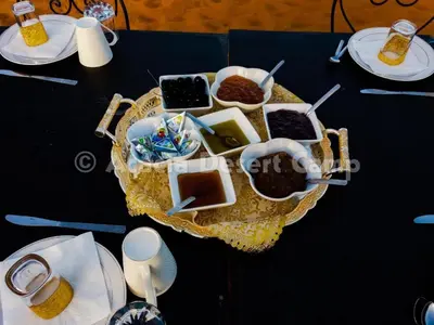 a table with a tray of food on a table at Acacia Desert Camp in Merzouga