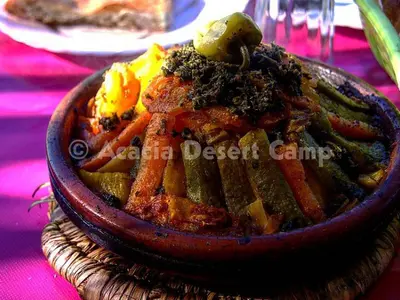 a bowl of food sitting on a table at Acacia Desert Camp in Merzouga