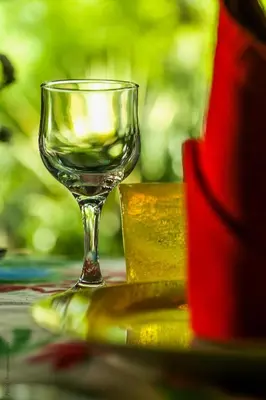 a wine glass sitting on top of a table at Riad Jardin Des Biehn in Fès