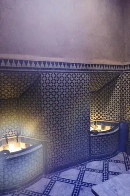 a bathroom with three urinals on a tiled wall at Riad Jardin Des Biehn in Fès