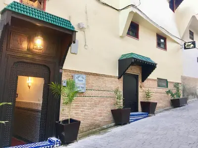 a store on a street with a building at Dar Fes Tresor in Fès