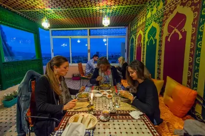 a group of women sitting at a table in a restaurant at Dar Fes Tresor in Fès