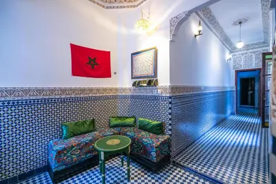 a living room with a couch and a table at Dar Fes Tresor in Fès