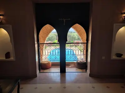 an open door into a church with a view of a pool at Kasbah ATFEL in Ourika
