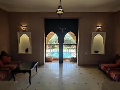 a living room with a view of a pool at Kasbah ATFEL in Ourika