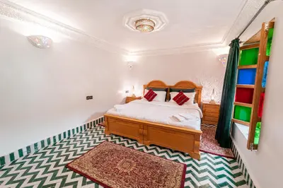 a bedroom with a bed in a room at Riad Taj Salma in Fès