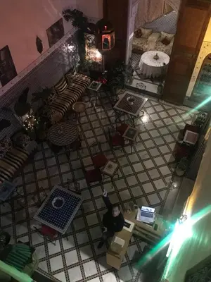 an overhead view of a room with a person sitting at a table at Riad Taj Salma in Fès