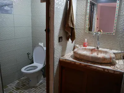 a bathroom with a sink and a toilet at Hotel Baddou in Tamtetoucht