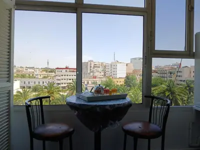a table with two chairs in front of a window at Ryan S3 in Fès