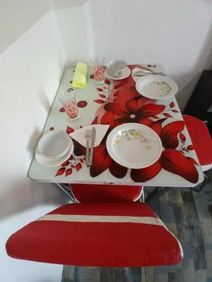 a table with plates and utensils on top of it at Ryan S3 in Fès