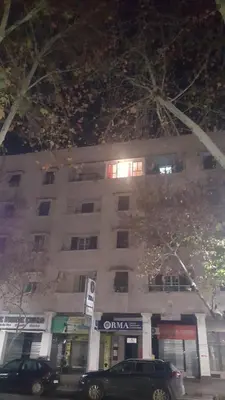 a large white building with cars parked in front of it at Ryan S3 in Fès
