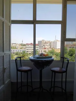 a table with two chairs in front of a window at Ryan S3 in Fès