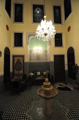 a large room with a chandelier in the middle of it at Riad Khouloud in Fès