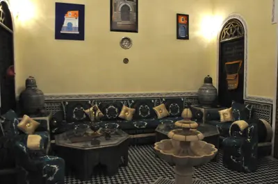 a living room with a couch and a table at Riad Khouloud in Fès