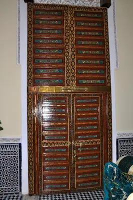 a large wooden door in a room at Riad Khouloud in Fès