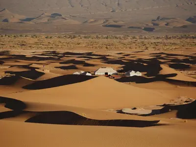 a small house in the middle of a desert at Nubia Luxury Camp Erg Chegaga in El Gouera