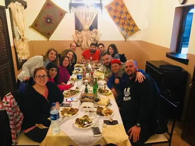 a group of people sitting around a table eating food at Kasbah Rayane Ait Ben Haddou in Aït Ben Haddou