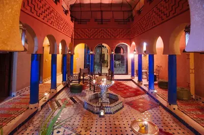 a room with a table and chairs in a building at Kasbah Rayane Ait Ben Haddou in Aït Ben Haddou