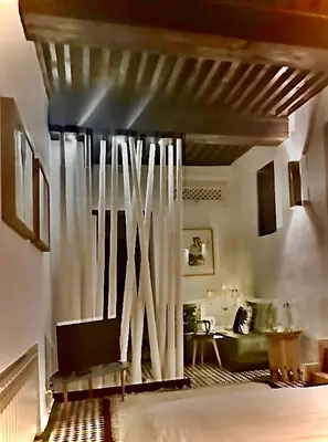 a living room with a bed and a couch at La Maison Maure in Fès
