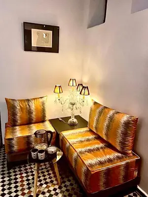a living room with two leather couches and a table at La Maison Maure in Fès