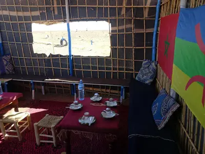 a room with a table with food and a window at Obira Oasis Merzouga Camp in Merzouga