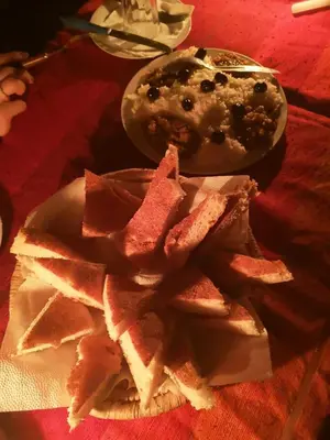 a plate of food with chips on a table at Obira Oasis Merzouga Camp in Merzouga