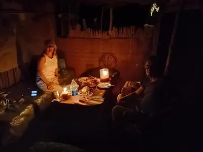 a group of people sitting around a table in a room at Obira Oasis Merzouga Camp in Merzouga