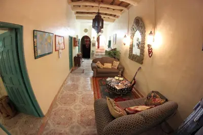 a large living room with couches and a table at Palmeraie Guest House in Tinerhir