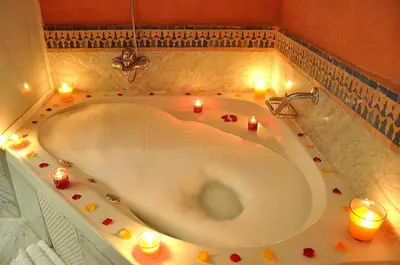a bath tub with candles in a room at Zalagh Parc Palace in Fès