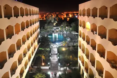 a view of a courtyard between two buildings at night at Zalagh Parc Palace in Fès