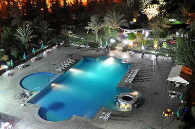 an overhead view of a swimming pool at night at Zalagh Parc Palace in Fès